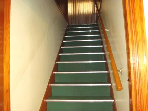 a view of stairs and a hall with wooden floor