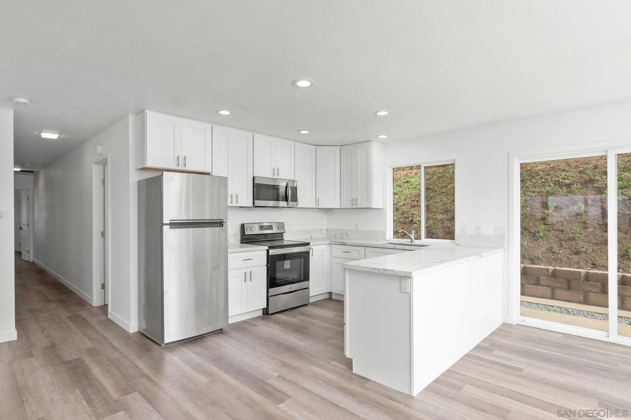 1940-44 Valley Rim Road El Cajon, CA 92021 - Photo 12 of 21 a kitchen with white cabinets and stainless steel appliances