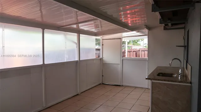 a view of a kitchen with white cabinets