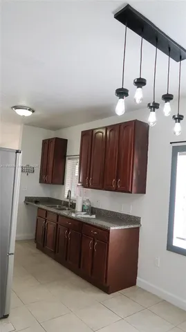 a kitchen with a refrigerator and a stove