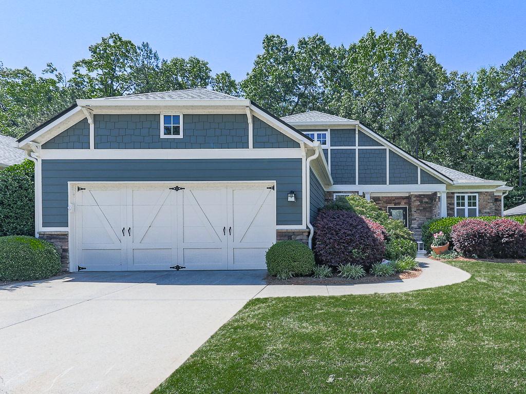 626 Laurel Crossing Canton, GA 30114 - Photo 2 of 77 a front view of a house with a yard and garage