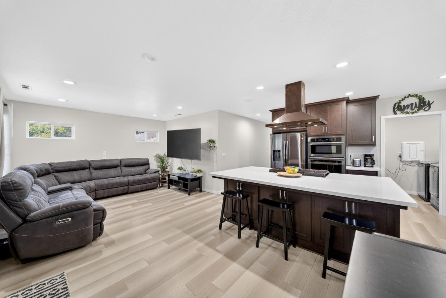 919 Old Canyon Road Fremont, CA 94536 - Photo 7 of 55 a living room with furniture kitchen view and a wooden floor