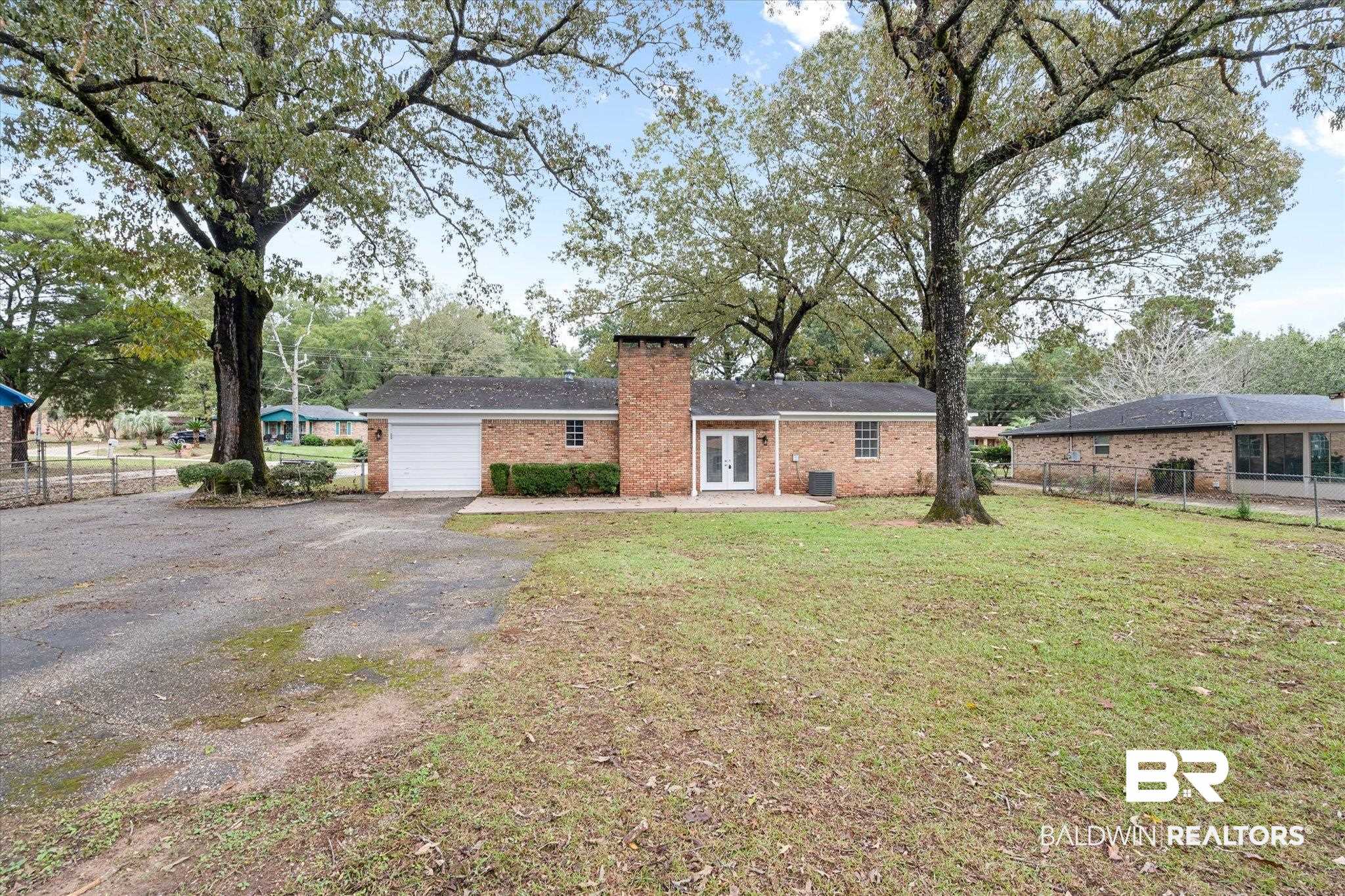 5015 Golfway Drive Eight Mile, AL 36613 - Photo 28 of 31 View of front of home featuring a front lawn, a garage, and french doors