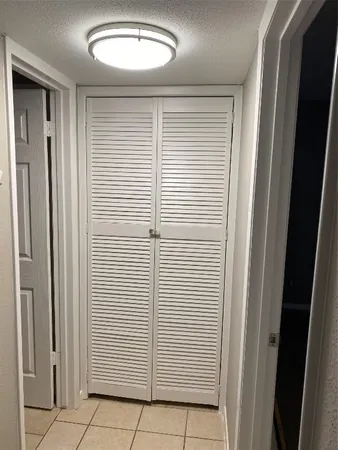 a view of a hallway to rooms
