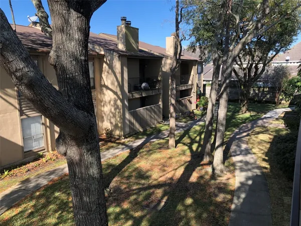 a view of a house with a tree