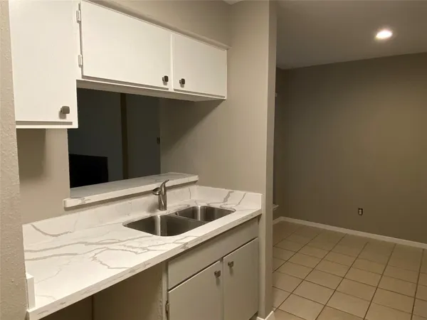 a kitchen with a sink and cabinets