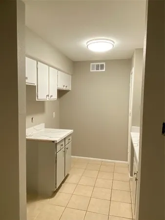 a view of a kitchen with a sink and cabinets