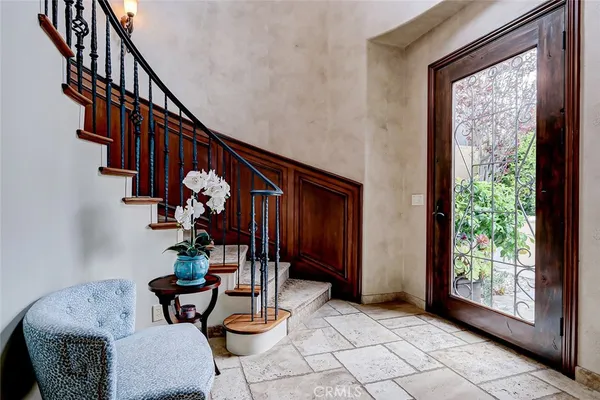 a living room with furniture and floor to ceiling windows