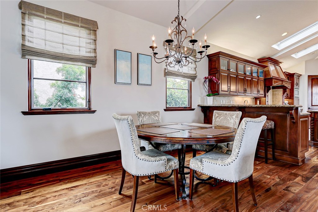 853 6th Street Manhattan Beach, CA 90266 - Photo 25 of 60 a view of a dining room with furniture a chandelier and wooden floor