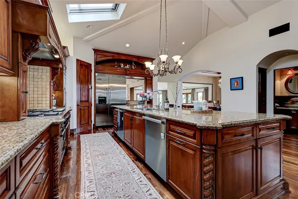 a bathroom with a bathtub shower sink mirror and toilet