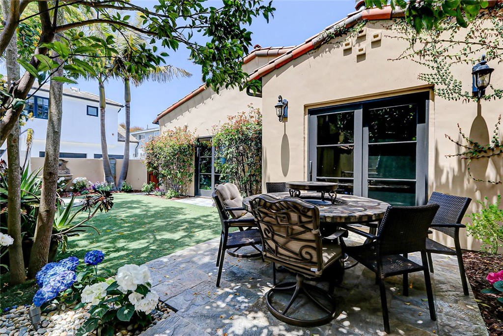 853 6th Street Manhattan Beach, CA 90266 - Photo 40 of 60 a view of a patio with table and chairs and potted plants