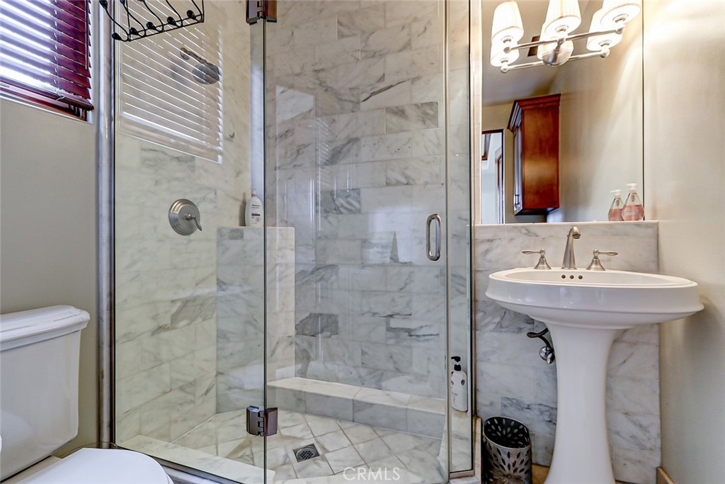 853 6th Street Manhattan Beach, CA 90266 - Photo 43 of 60 a bathroom with a bathtub shower sink mirror and toilet