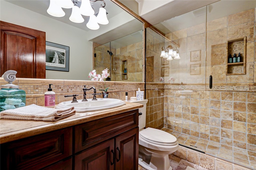 853 6th Street Manhattan Beach, CA 90266 - Photo 49 of 60 a bathroom with a sink a toilet and mirror