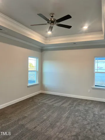 en empty room with window and ceiling fan