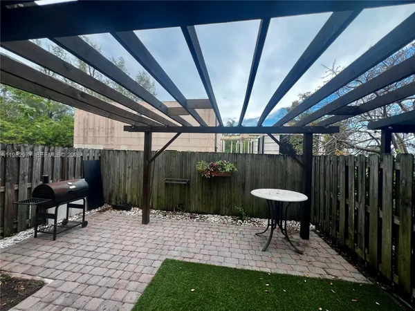 a view of a porch with furniture and a yard