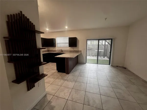 a view of kitchen with windows cabinet and microwave