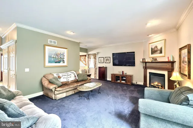 a living room with furniture flat screen tv and a fireplace