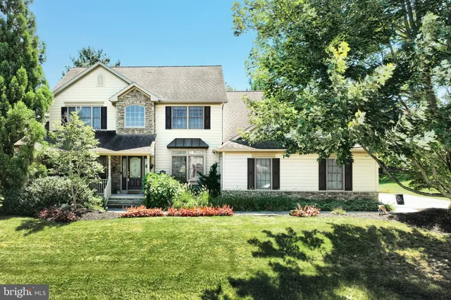 a front view of house with yard and green space