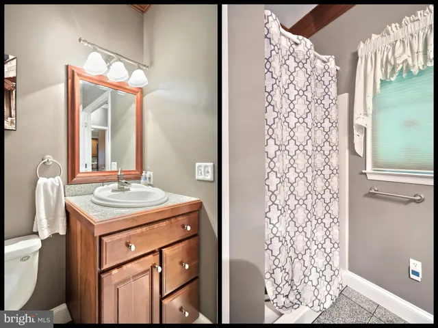 a bathroom with a sink toilet vanity and shower