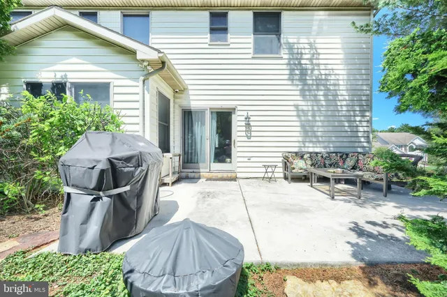 a view of a patio with table and chairs and potted plants