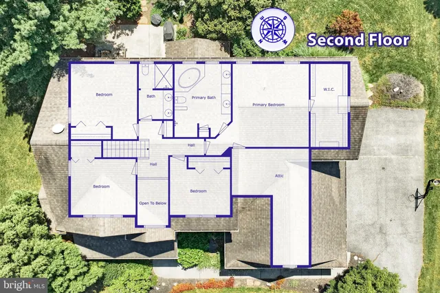 an aerial view of residential house with sign board and yard