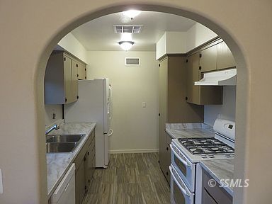 219 Larkspur Street Ridgecrest, CA 93555 - Photo 10 of 34 a kitchen with stainless steel appliances a sink stove and refrigerator