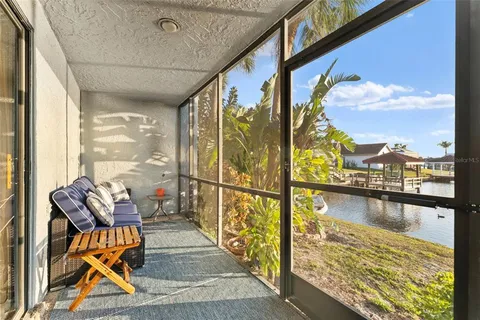 a balcony with chairs and wooden floor