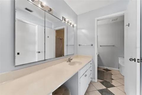 a bathroom with a double vanity sink mirror and shower