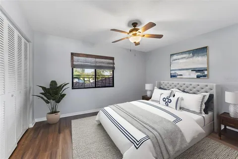 a bedroom with a large bed and a chandelier