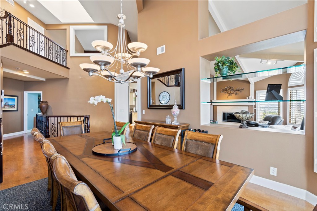 33662 Holtz Hill Drive Dana Point, CA 92629 - Photo 19 of 75 a view of a dining room with furniture a chandelier and large windows