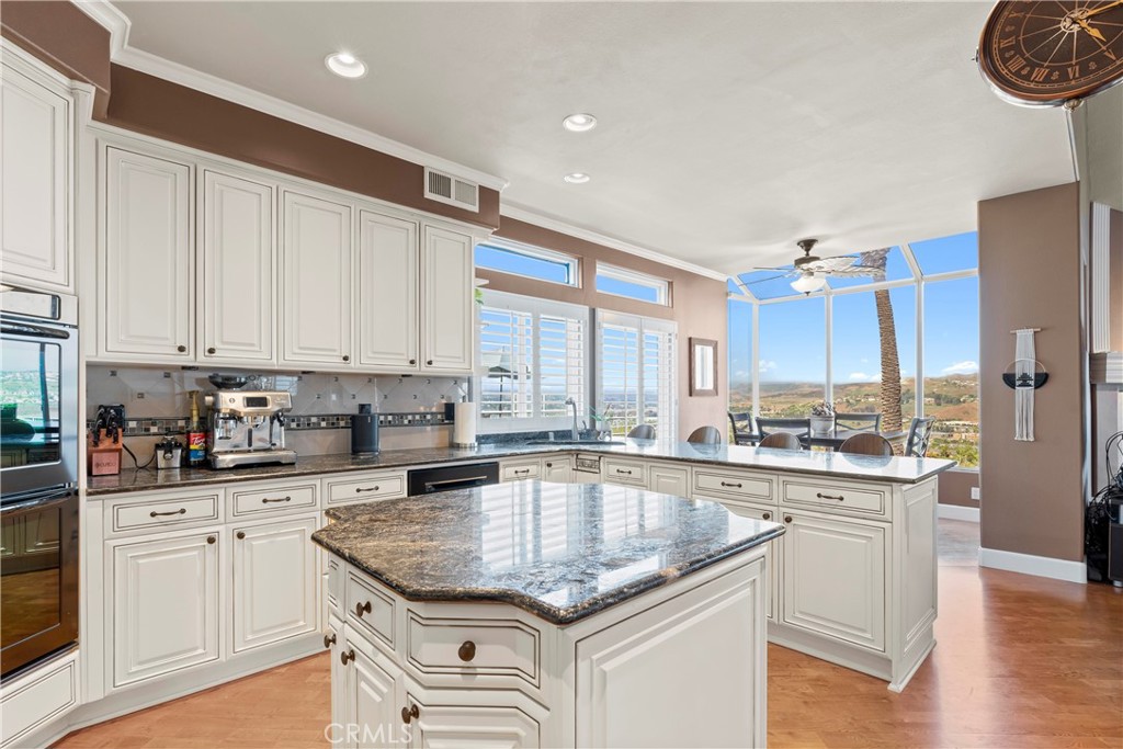 33662 Holtz Hill Drive Dana Point, CA 92629 - Photo 31 of 75 a kitchen with stainless steel appliances granite countertop a sink stove and cabinets