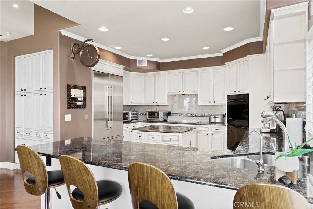 33662 Holtz Hill Drive Dana Point, CA 92629 - Photo 35 of 75 a kitchen with stainless steel appliances granite countertop a sink and a refrigerator