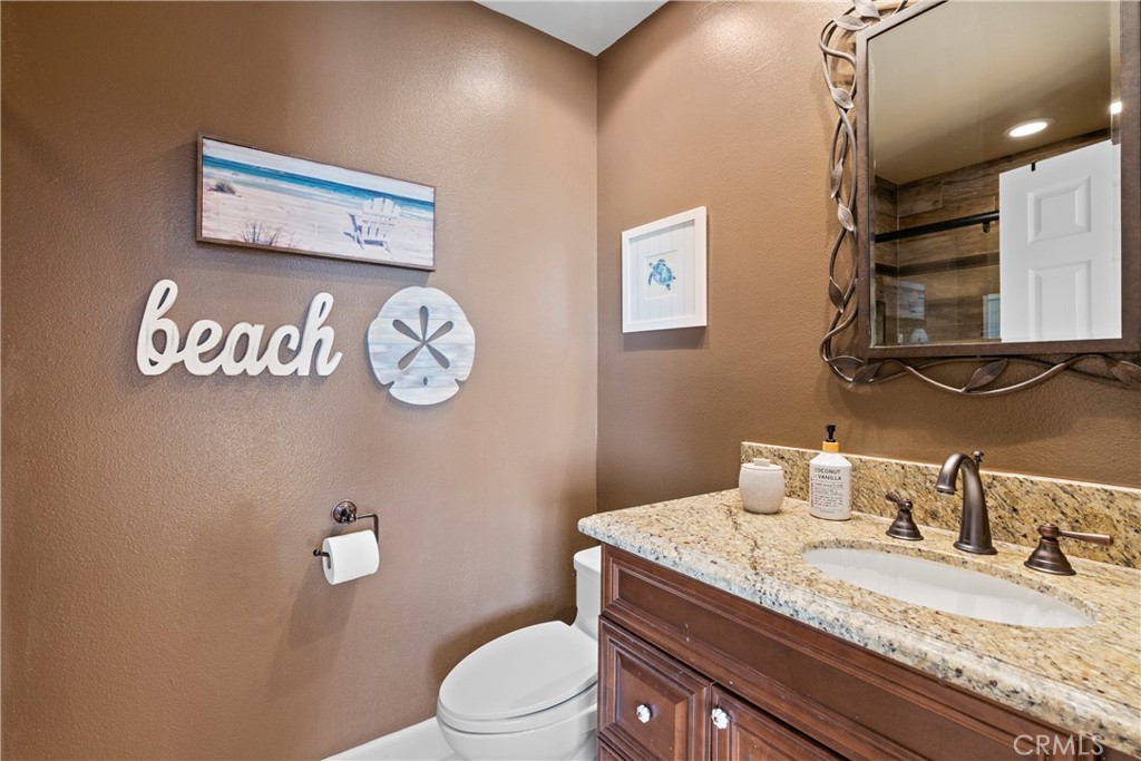 33662 Holtz Hill Drive Dana Point, CA 92629 - Photo 43 of 75 a bathroom with a granite countertop toilet sink and mirror
