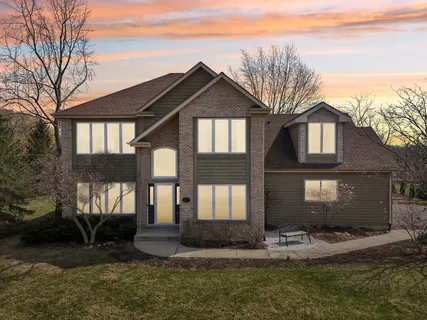a front view of a house with a yard garage and outdoor seating