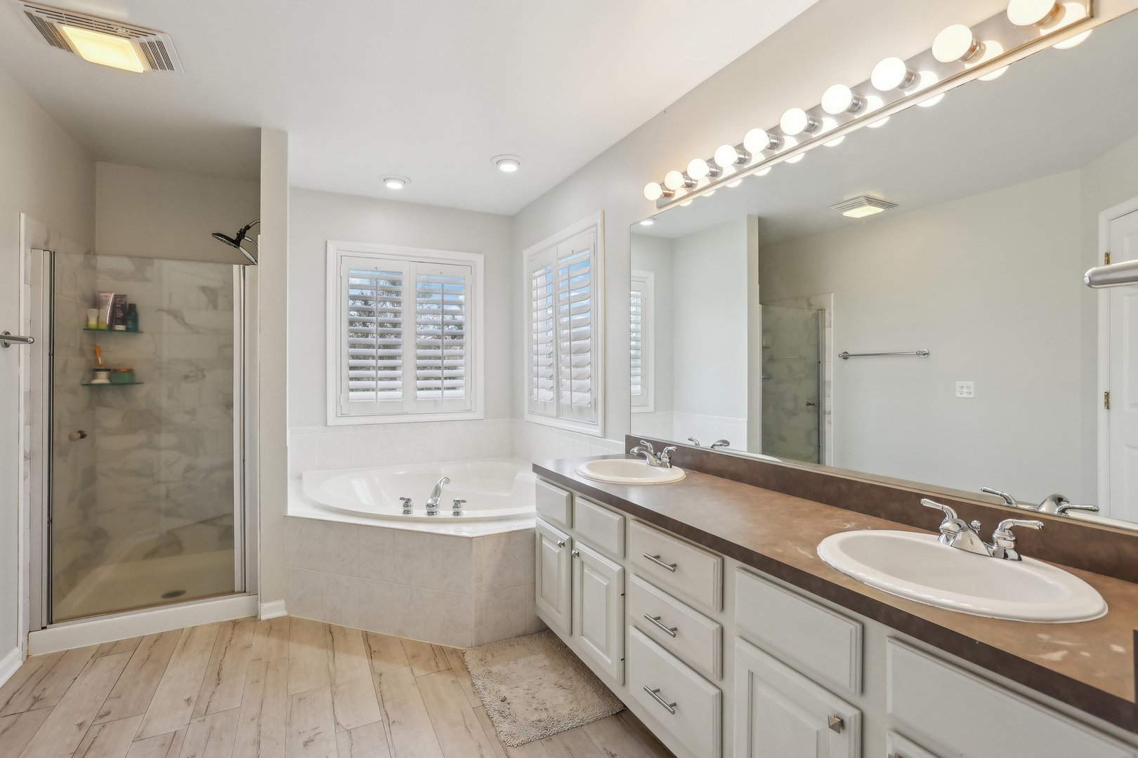 40783 Gridley Drive Antioch, IL 60002 - Photo 21 of 44 a spacious bathroom with a double vanity sink a large mirror and shower
