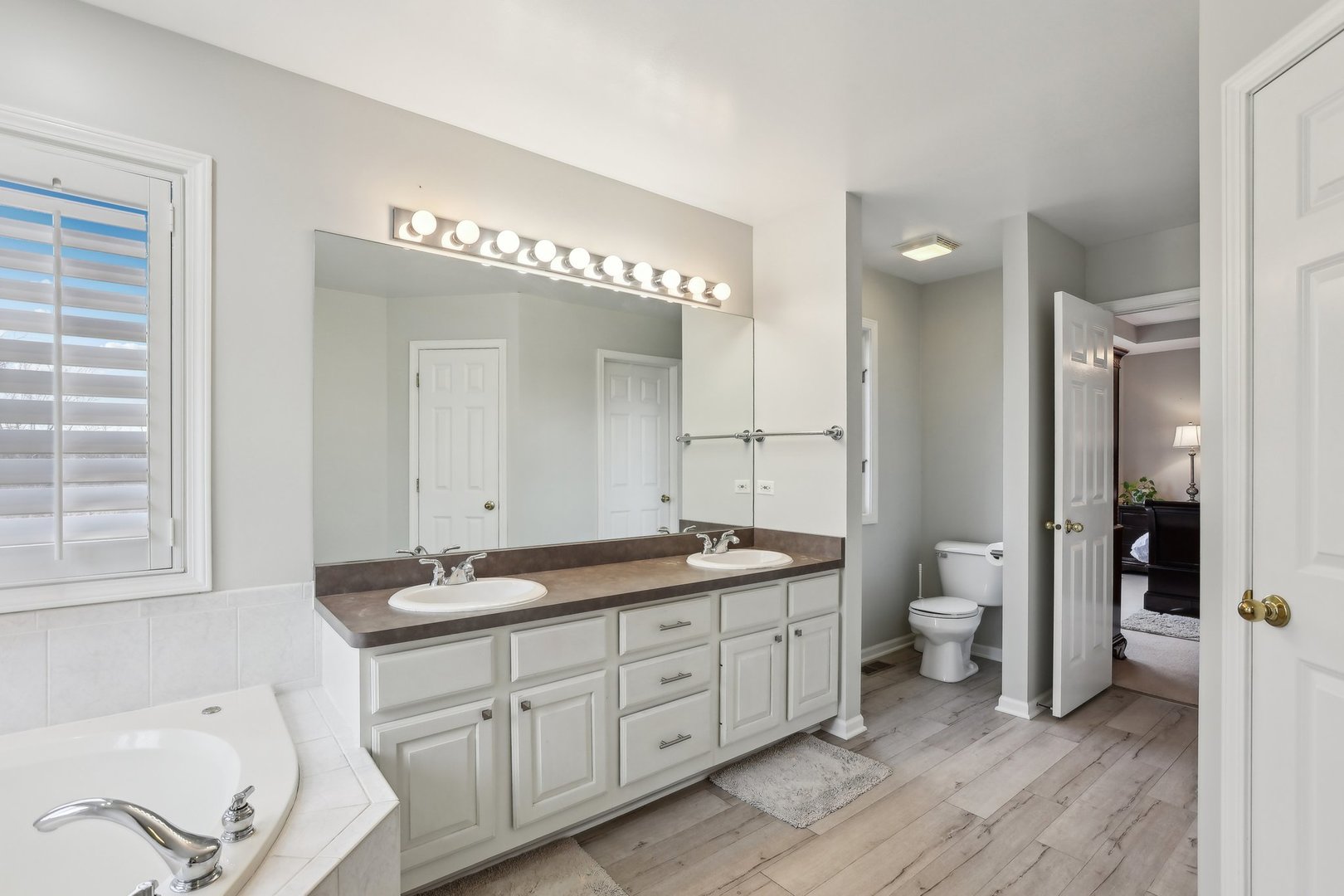 40783 Gridley Drive Antioch, IL 60002 - Photo 22 of 44 a spacious bathroom with a granite countertop sink mirror and toilet