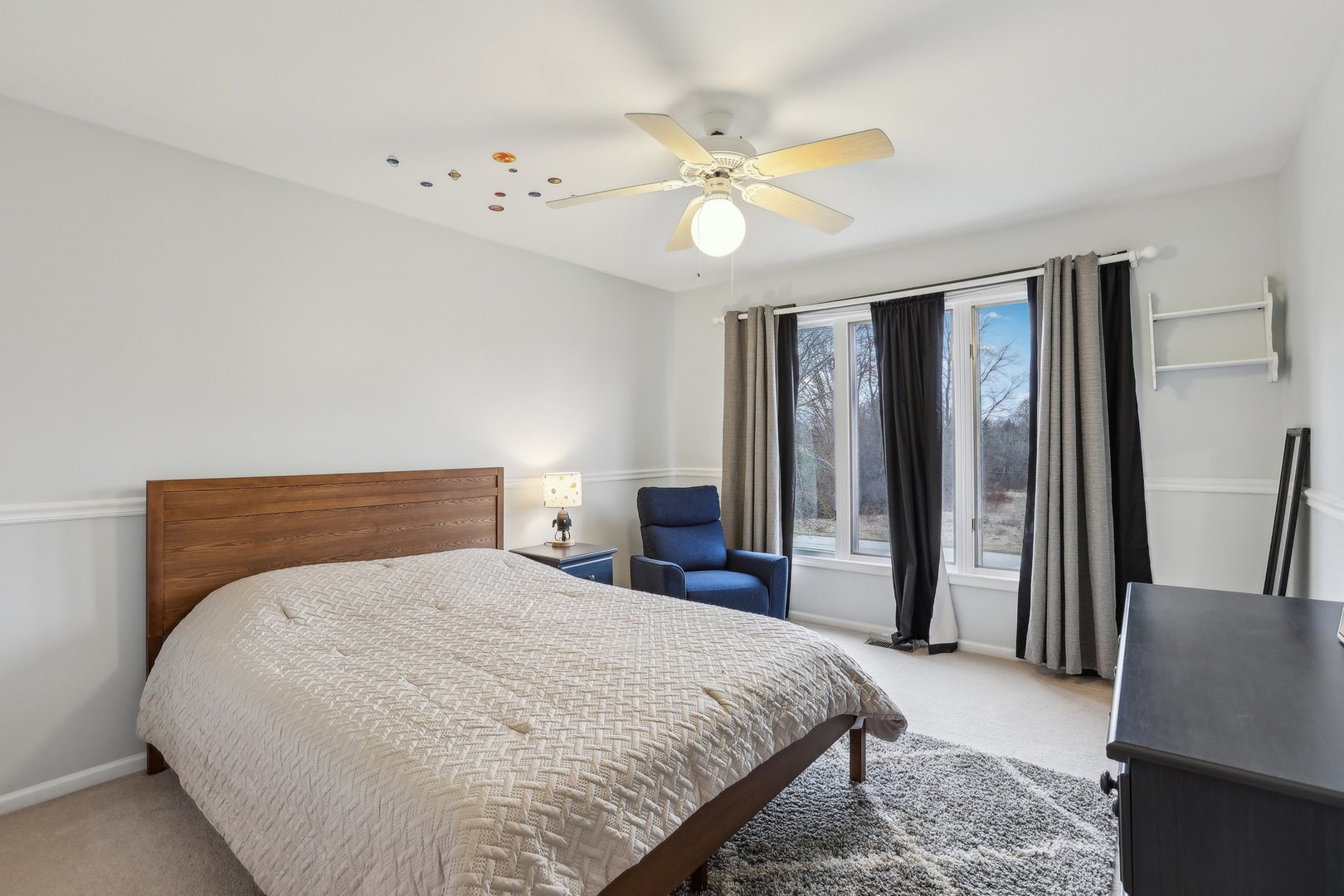 40783 Gridley Drive Antioch, IL 60002 - Photo 26 of 44 a bedroom with a large bed and a chandelier