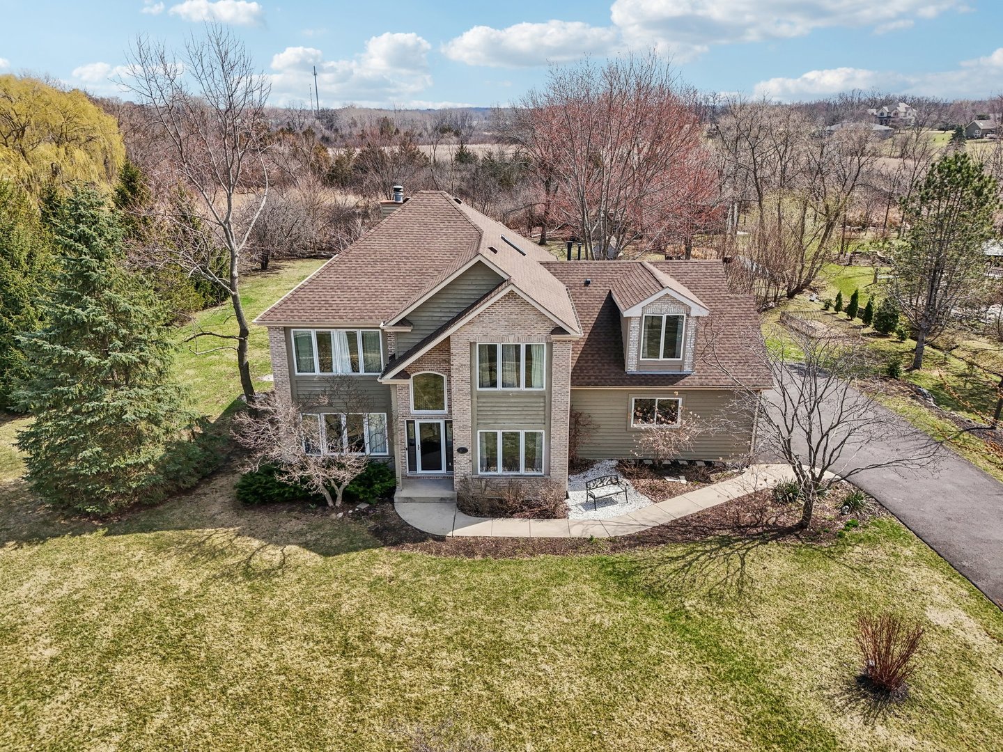 40783 Gridley Drive Antioch, IL 60002 - Photo 38 of 44 a front view of a house with a yard fountain and large tree