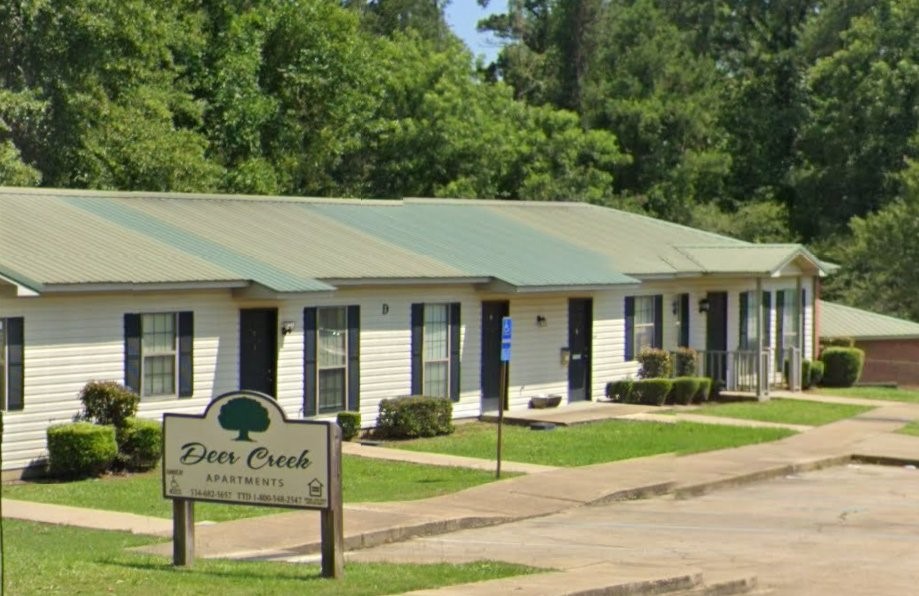 a view of a house with a yard patio and a garden