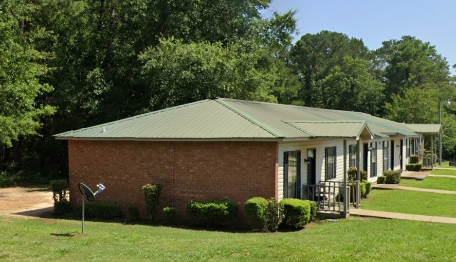 1015 Whiskey Run Road Camden, AL 36726 - Photo 6 of 6 a backyard of a house with plants and large tree