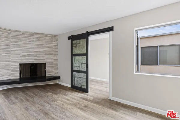 a view of a livingroom with a fireplace and window