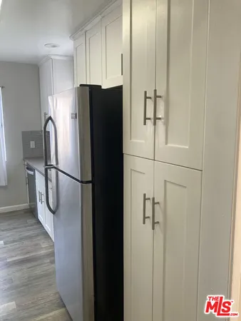 a kitchen with stainless steel appliances a refrigerator and cabinets