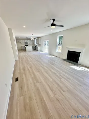 a view of kitchen and hall with wooden floor