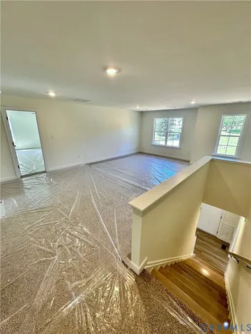 a view of a room with window and wooden floor