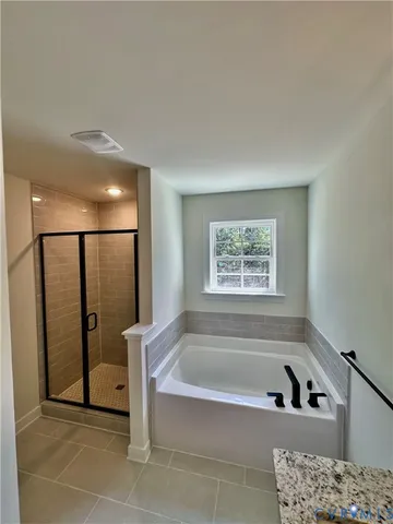a bathroom with a bathtub and a shower