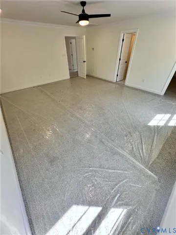 a view of a room with a ceiling fan