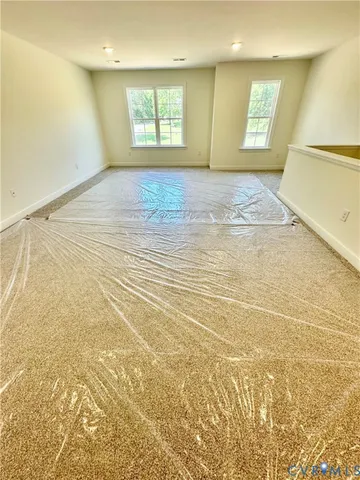 a view of an empty room and a window