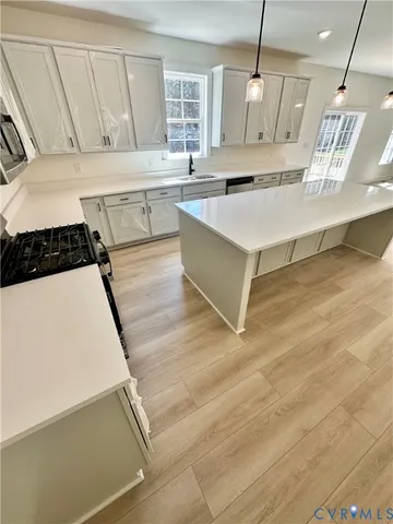 a kitchen with a sink a stove and cabinets