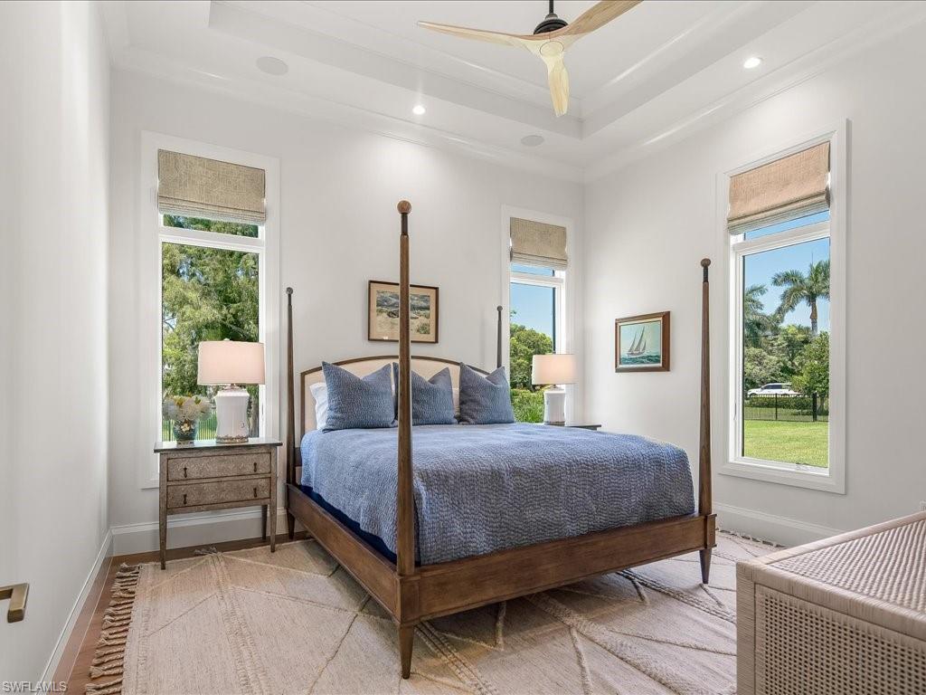 142 Eugenia Drive Naples, FL 34108 - Photo 21 of 35 a bedroom with a bed a window and potted plant on the dresser