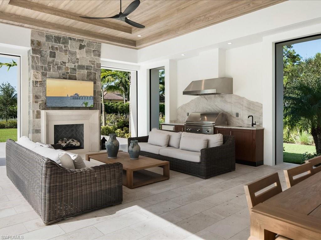 142 Eugenia Drive Naples, FL 34108 - Photo 30 of 35 a living room with furniture and a fireplace